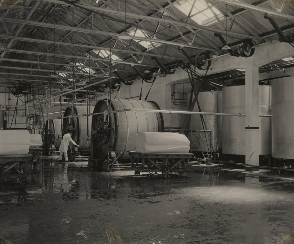 Photograph of butter and machinery with machine operator.