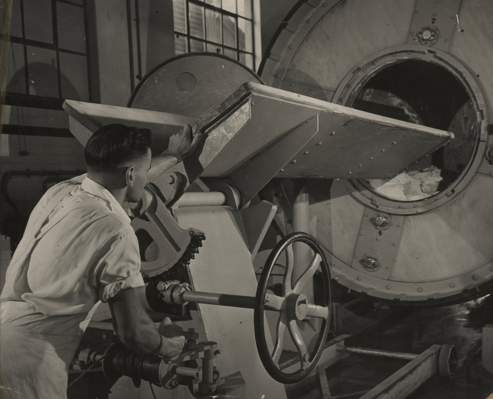 Photograph of butter churner and worker.