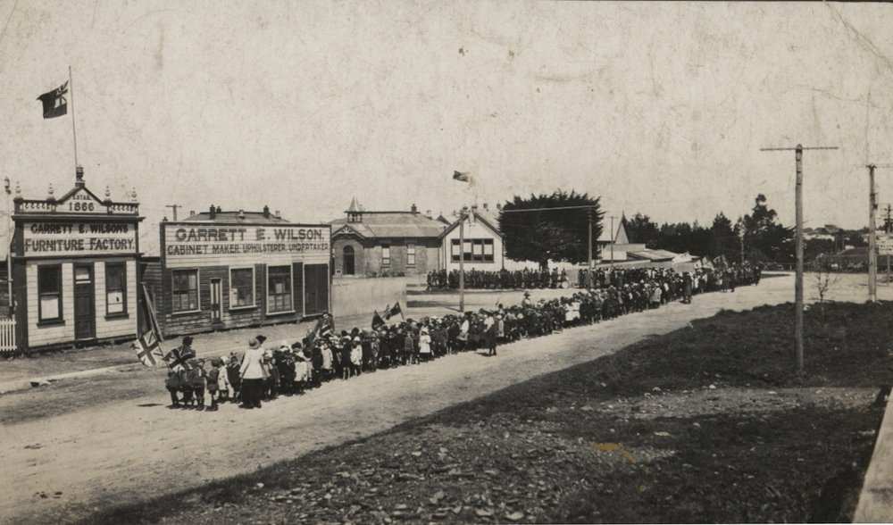 School children waving flags in the street 