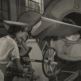 Photograph of butter churner and worker.