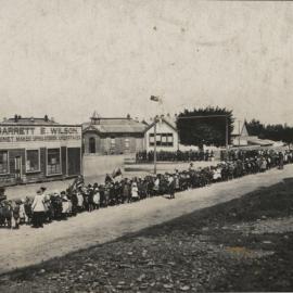 School children waving flags in the street 